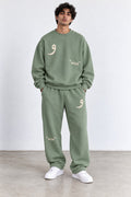 Classic Set in Green, front view with the Arabic letter on the chest and leg