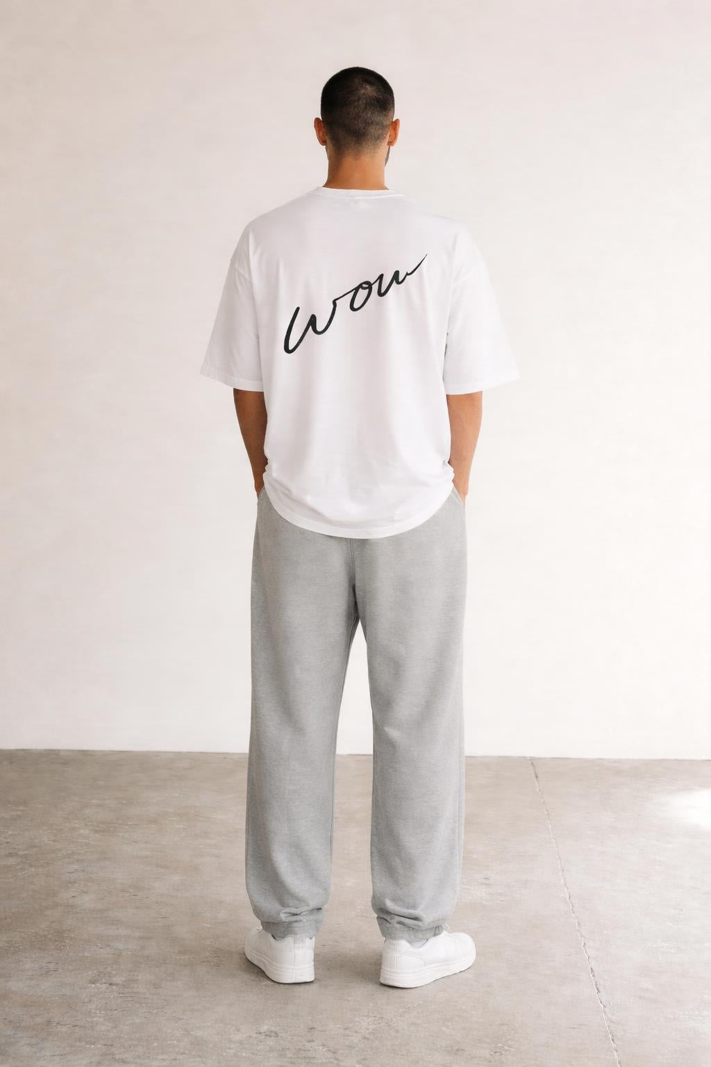 Back pose of the model wearing Classic Handwritten Tee White