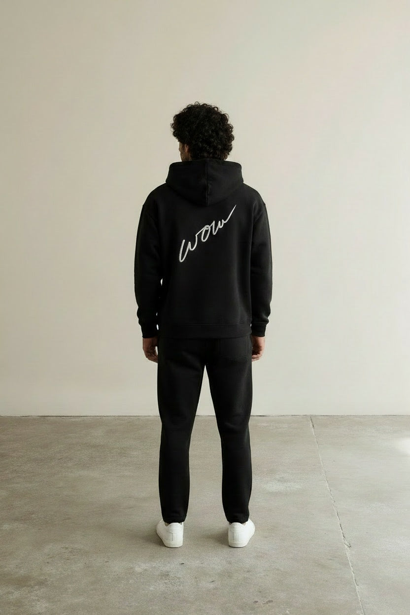 Back pose of the model wearing Box Logo Hoodie Black