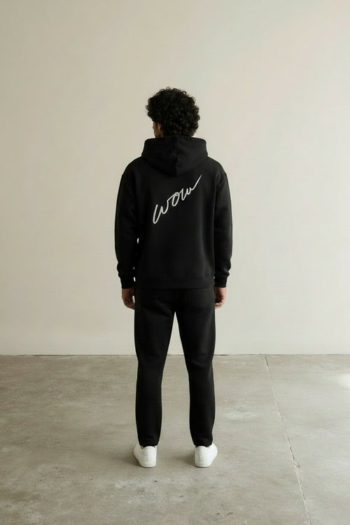 Back pose of the model wearing Box Logo Hoodie Black