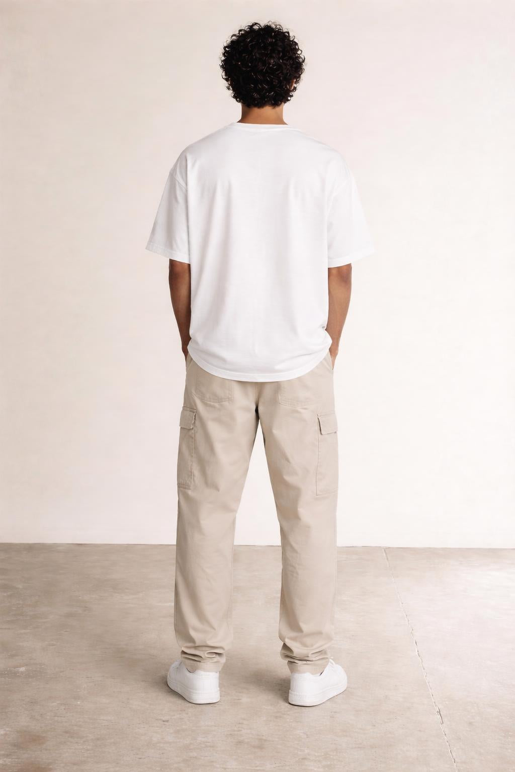 Back pose of the model wearing Mini Logo Tee