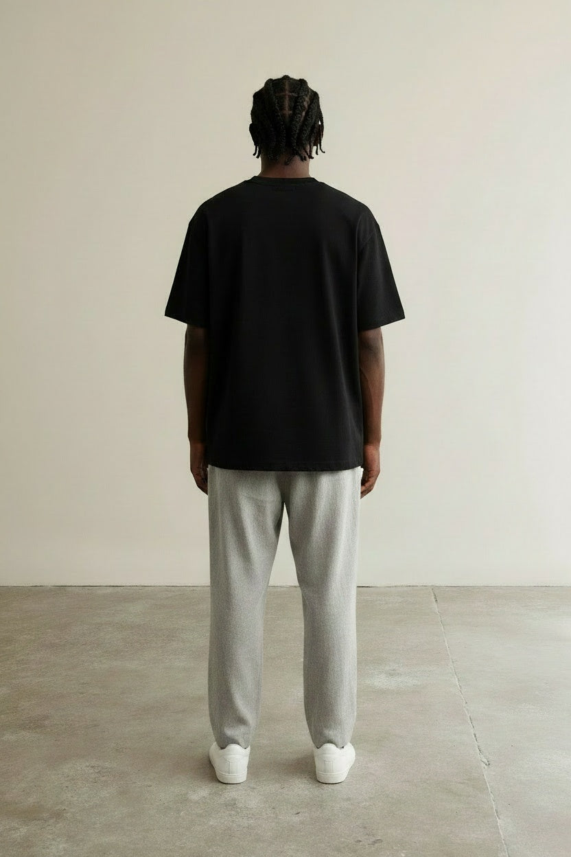 Back pose of the model wearing Mini Logo Tee Black